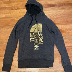 The North Face Women’s Charcoal Hoodie with Gold Logo.